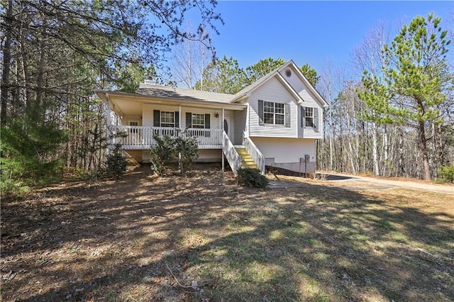 tri-level home featuring a porch, a chimney, and stairway