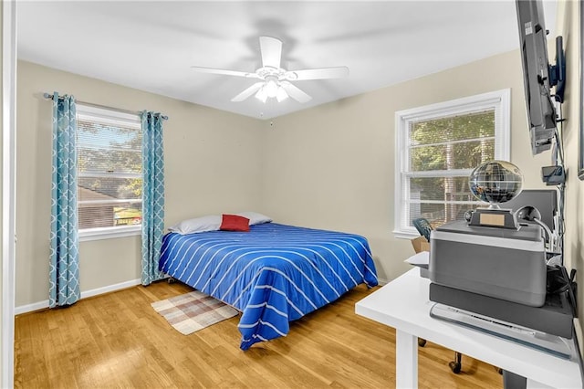 288 Valerie Cir, Hiram, GA 30141 - bedroom with multiple windows, wood finished floors, and a ceiling fan