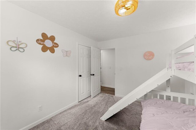 carpeted bedroom featuring baseboards