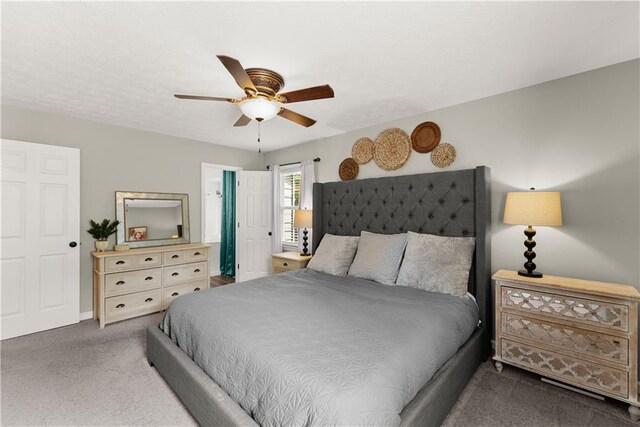 carpeted bedroom featuring baseboards and a ceiling fan