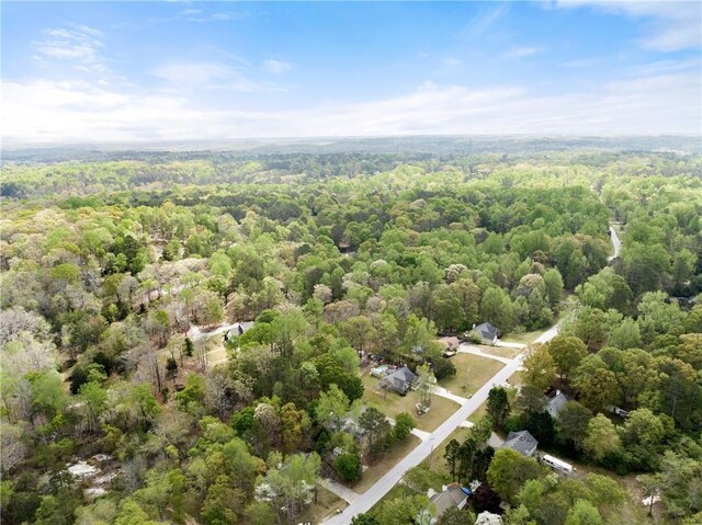 drone / aerial view featuring a forest view
