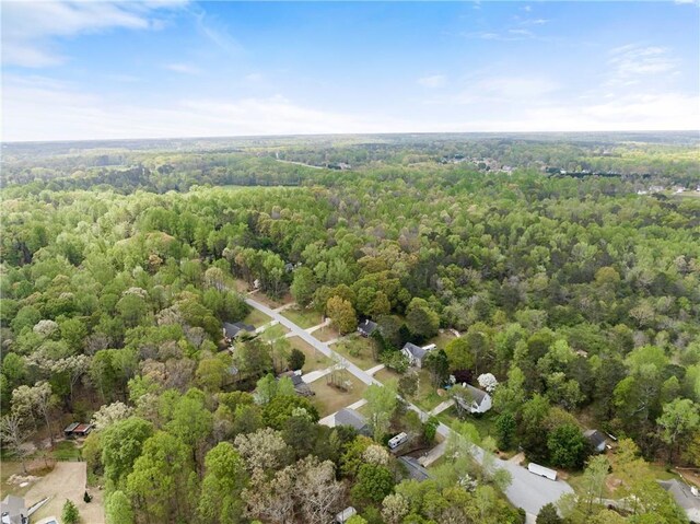 birds eye view of property featuring a view of trees