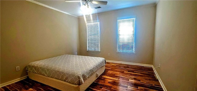 bedroom featuring visible vents, a ceiling fan, ornamental molding, dark wood-type flooring, and baseboards