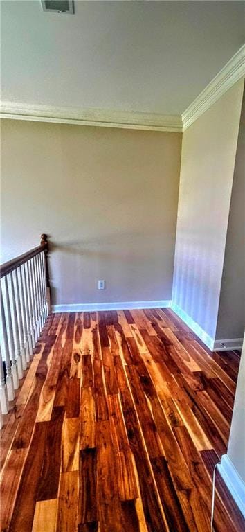 spare room featuring hardwood / wood-style floors, baseboards, and ornamental molding