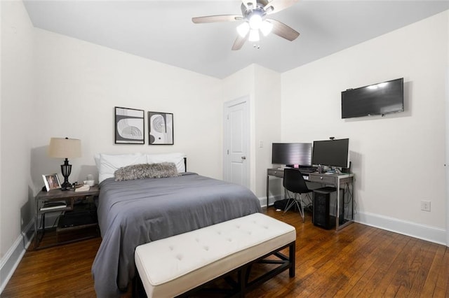 bedroom with dark hardwood / wood-style flooring and ceiling fan