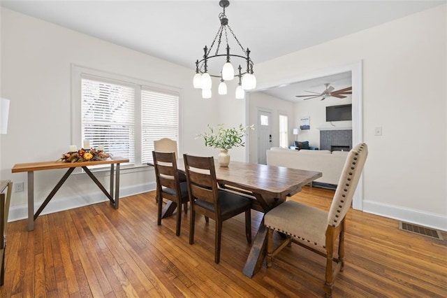 dining room featuring a fireplace and hardwood / wood-style floors