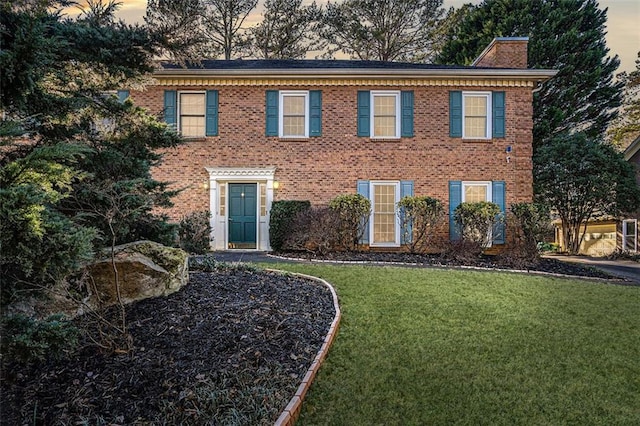 colonial-style house with a yard