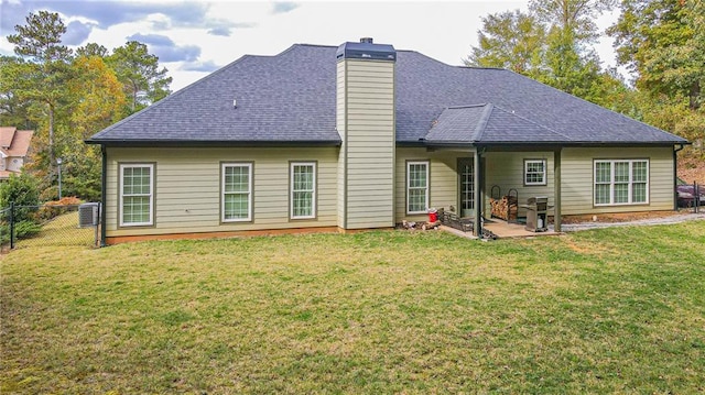 back of house featuring a lawn, a patio area, and central air condition unit