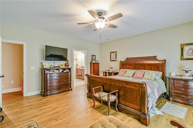 bedroom featuring ensuite bath, ceiling fan, and light wood-type flooring