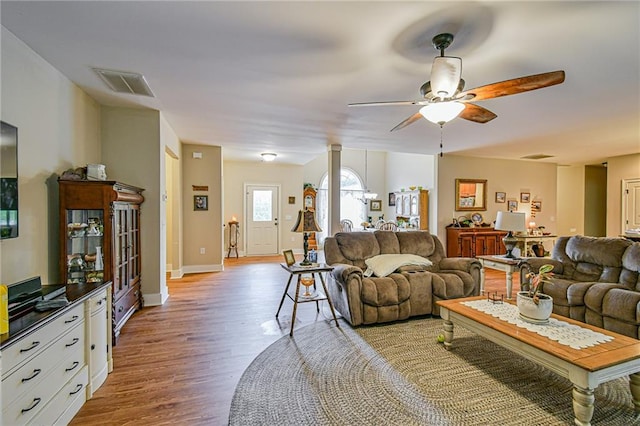 living room with ceiling fan and light hardwood / wood-style floors