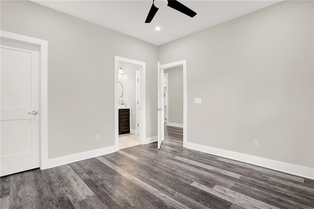 unfurnished bedroom featuring ceiling fan, wood-type flooring, and connected bathroom