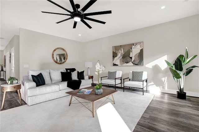 living room with hardwood / wood-style flooring and ceiling fan