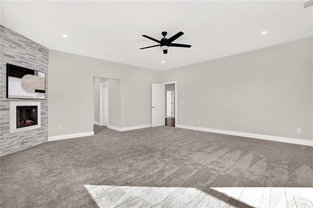 unfurnished living room featuring carpet, ceiling fan, and a fireplace