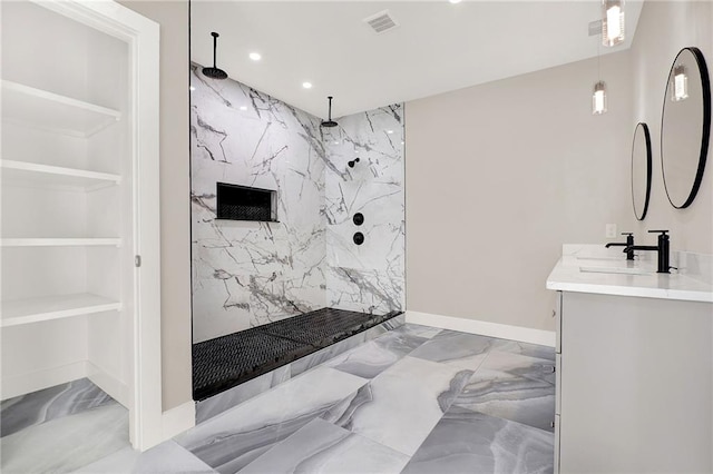 bathroom with a shower, built in shelves, and vanity