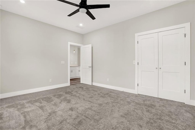 unfurnished bedroom with carpet, ceiling fan, and a closet