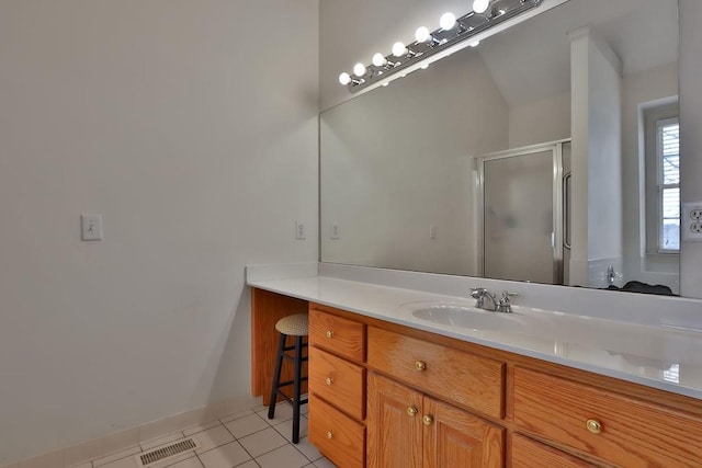 bathroom featuring vanity, walk in shower, and tile patterned floors