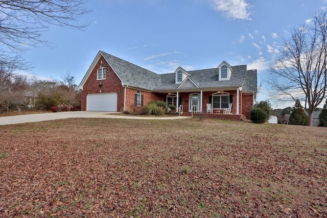 cape cod-style house featuring a porch and a front yard