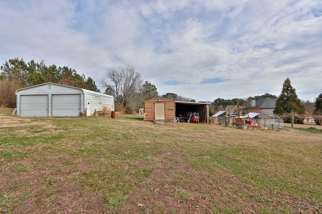 view of yard with a garage and a storage shed