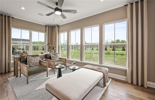 sunroom / solarium featuring ceiling fan