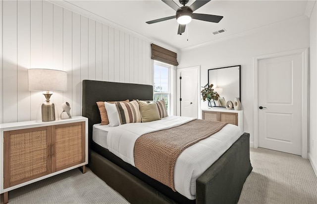 carpeted bedroom with ceiling fan and crown molding