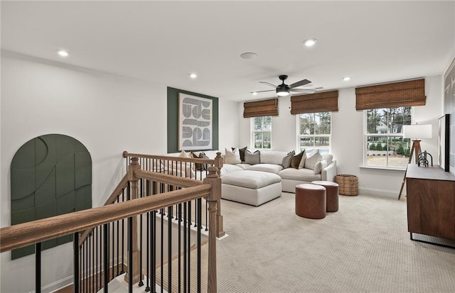 carpeted living room with ceiling fan