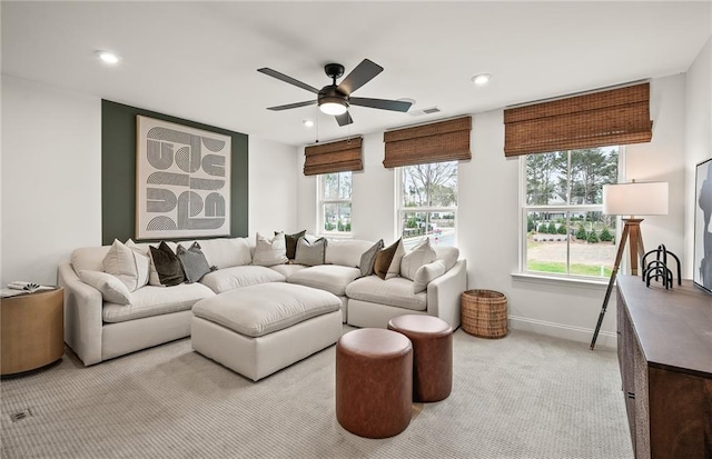 living room with light colored carpet and ceiling fan