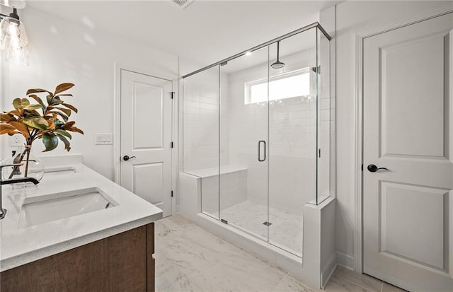 bathroom with vanity and a shower with shower door