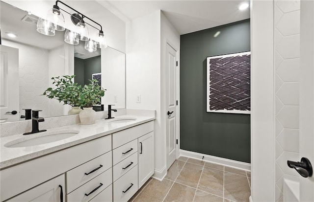 bathroom with tile patterned floors and vanity