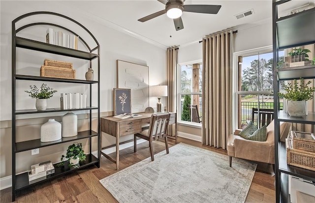 office space featuring ceiling fan, crown molding, and dark hardwood / wood-style flooring