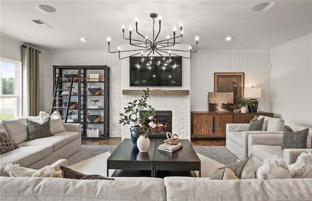 living room with a fireplace, a notable chandelier, hardwood / wood-style flooring, and wooden walls