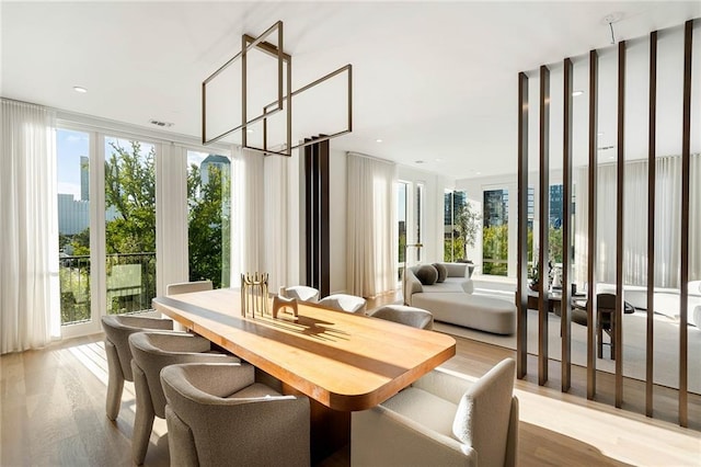 dining area with plenty of natural light and light hardwood / wood-style flooring