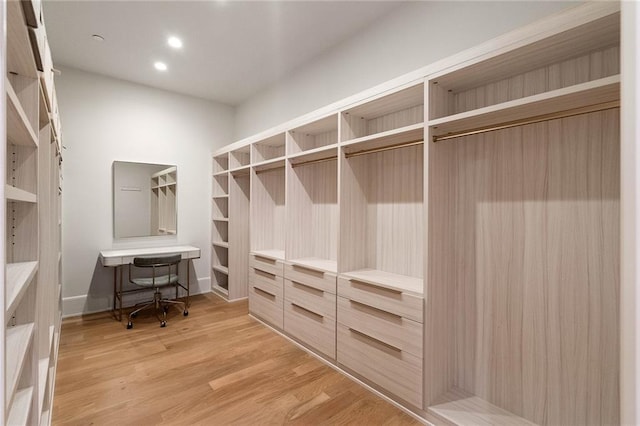 spacious closet featuring light hardwood / wood-style floors