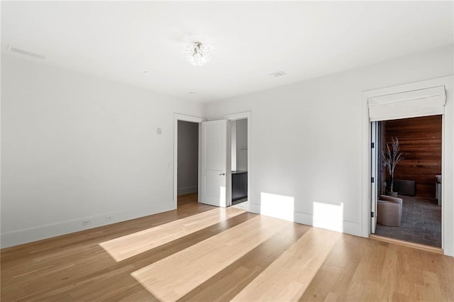 unfurnished bedroom featuring light wood-type flooring and a closet