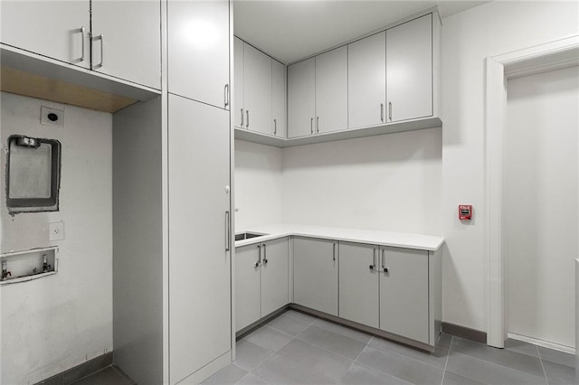 clothes washing area with cabinets, washer hookup, hookup for an electric dryer, and light tile patterned flooring