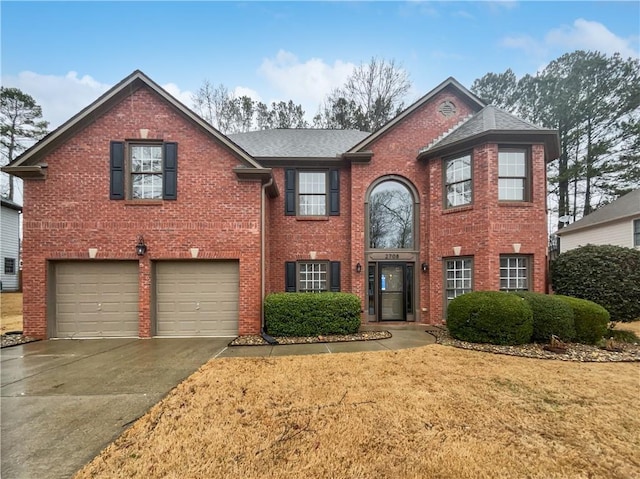 view of front facade with driveway, brick siding, a front lawn, and an attached garage