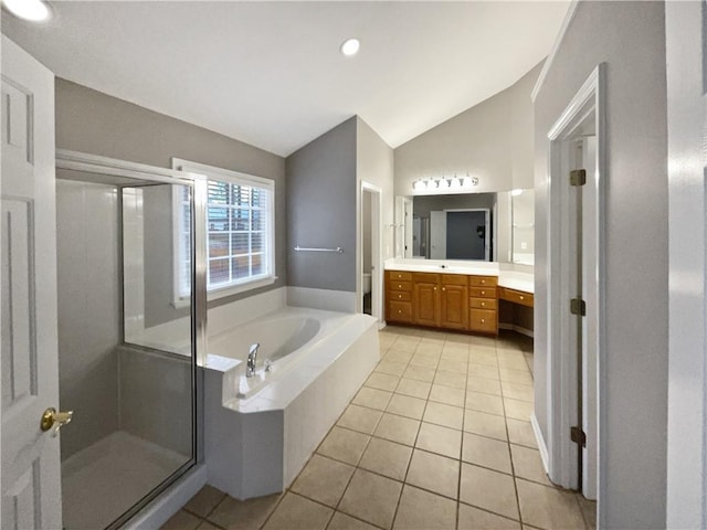 bathroom featuring a shower stall, vaulted ceiling, a bath, and vanity