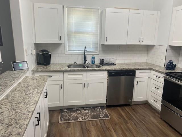 kitchen featuring decorative backsplash, dark wood-style floors, appliances with stainless steel finishes, white cabinetry, and a sink