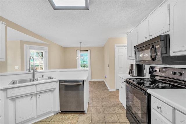 kitchen with white cabinetry, black appliances, light countertops, and a sink