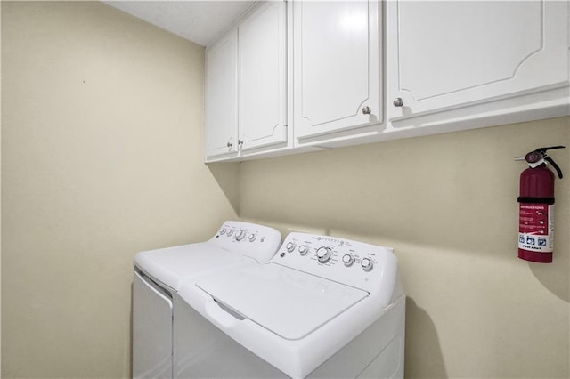 washroom featuring cabinet space and independent washer and dryer