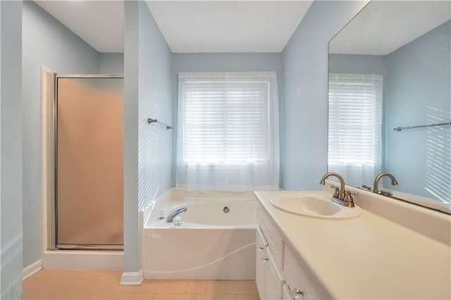 bathroom featuring a bath, tile patterned flooring, a stall shower, and vanity