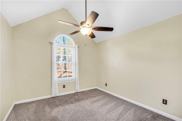 carpeted spare room with a ceiling fan, baseboards, and vaulted ceiling