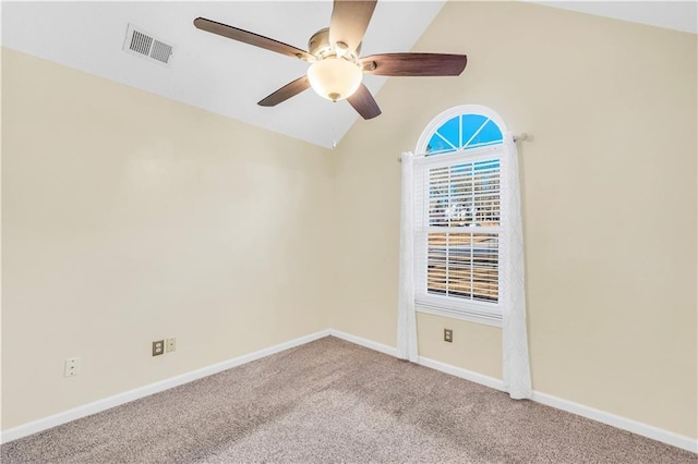 carpeted empty room featuring visible vents, ceiling fan, baseboards, and lofted ceiling