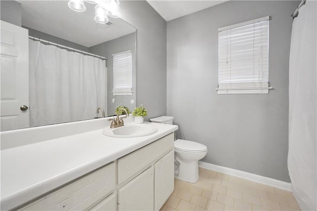 full bath featuring toilet, vanity, and baseboards