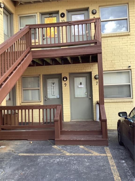 view of exterior entry featuring a balcony