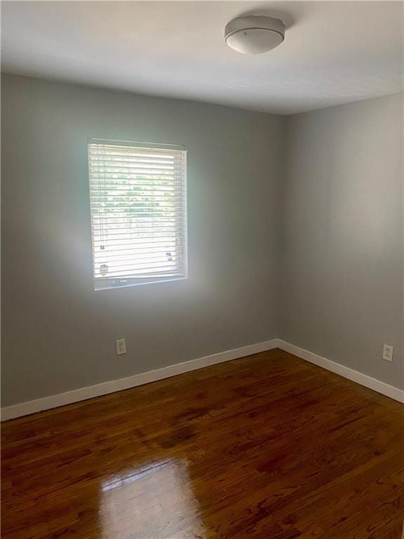 spare room with dark wood-type flooring