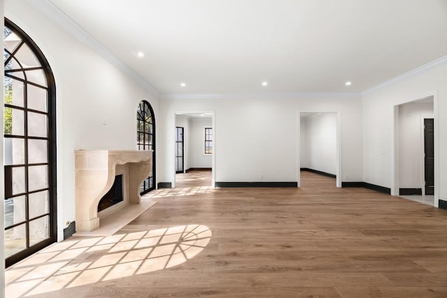 650 Moores Mill Rd NW Unit 1, Atlanta, GA 30327 - unfurnished living room featuring healthy amount of natural light, a premium fireplace, recessed lighting, wood finished floors, and ornamental molding