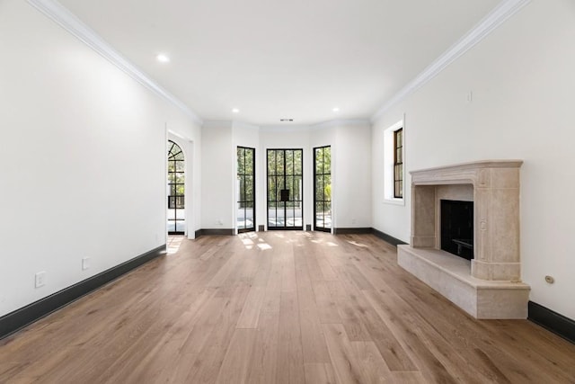 650 Moores Mill Rd NW Unit 1, Atlanta, GA 30327 - unfurnished living room featuring light wood-type flooring, crown molding, recessed lighting, and a high end fireplace