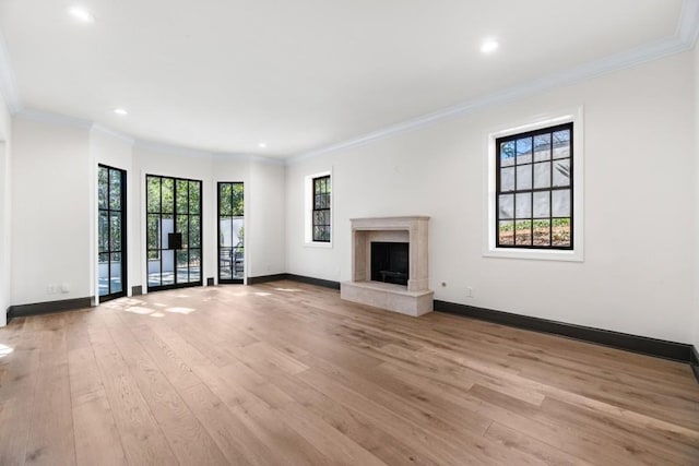 650 Moores Mill Rd NW Unit 1, Atlanta, GA 30327 - unfurnished living room with plenty of natural light, light wood-style floors, a high end fireplace, recessed lighting, and crown molding