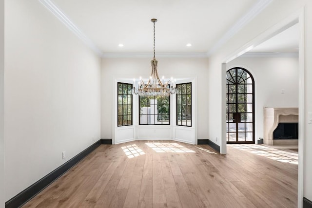 650 Moores Mill Rd NW Unit 1, Atlanta, GA 30327 - unfurnished dining area with healthy amount of natural light, a chandelier, wood finished floors, crown molding, and recessed lighting