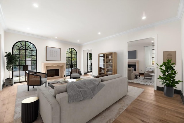 650 Moores Mill Rd NW Unit 1, Atlanta, GA 30327 - living area with a fireplace with raised hearth, wood finished floors, healthy amount of natural light, crown molding, and recessed lighting